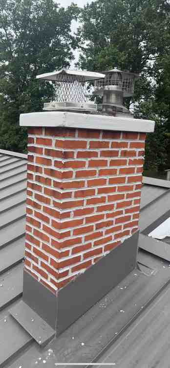 Brick chimney with new crown, flashing and two stainless chimney caps