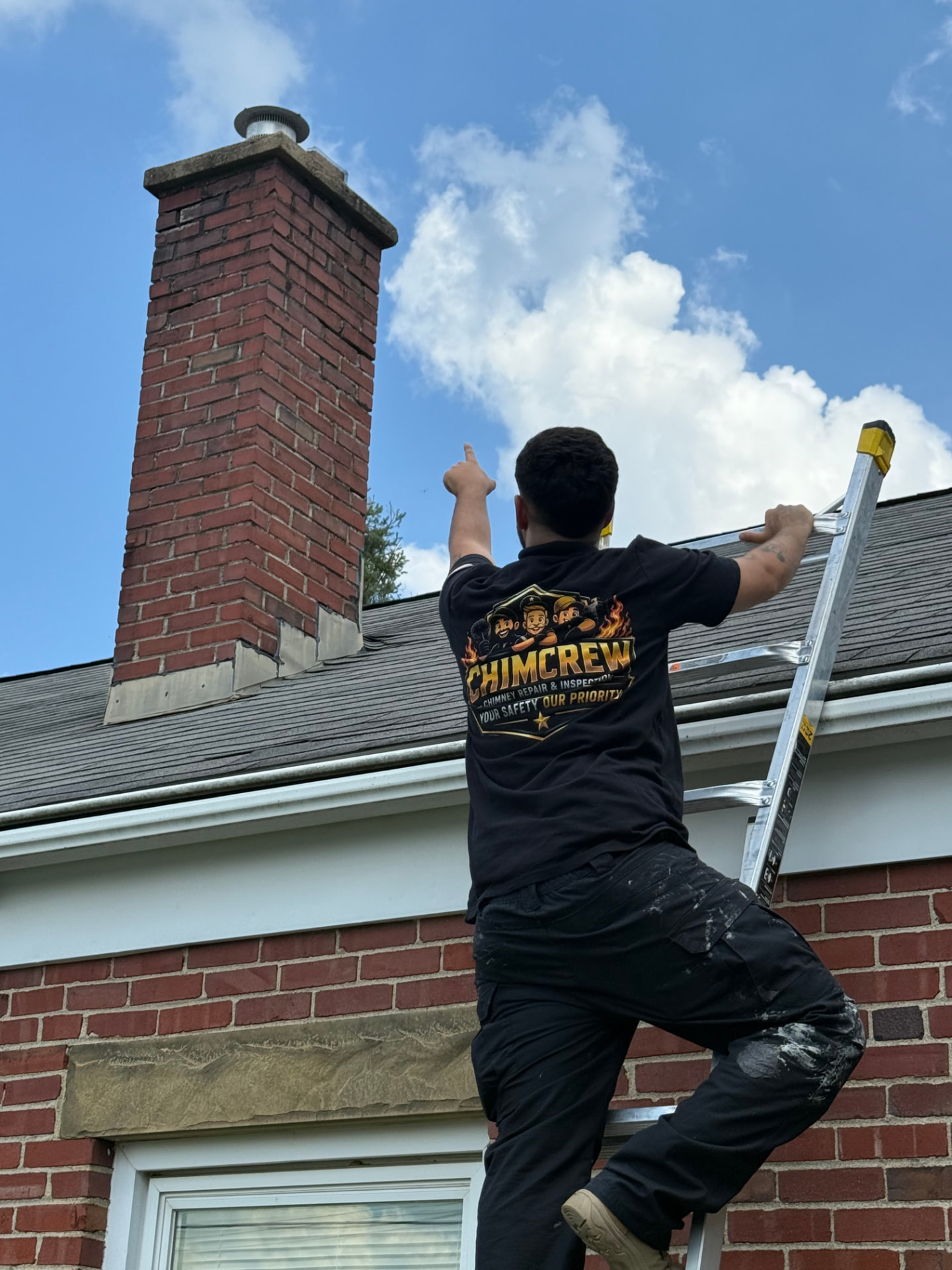 ChimCrew technician inspecting a brick chimney from the roofline